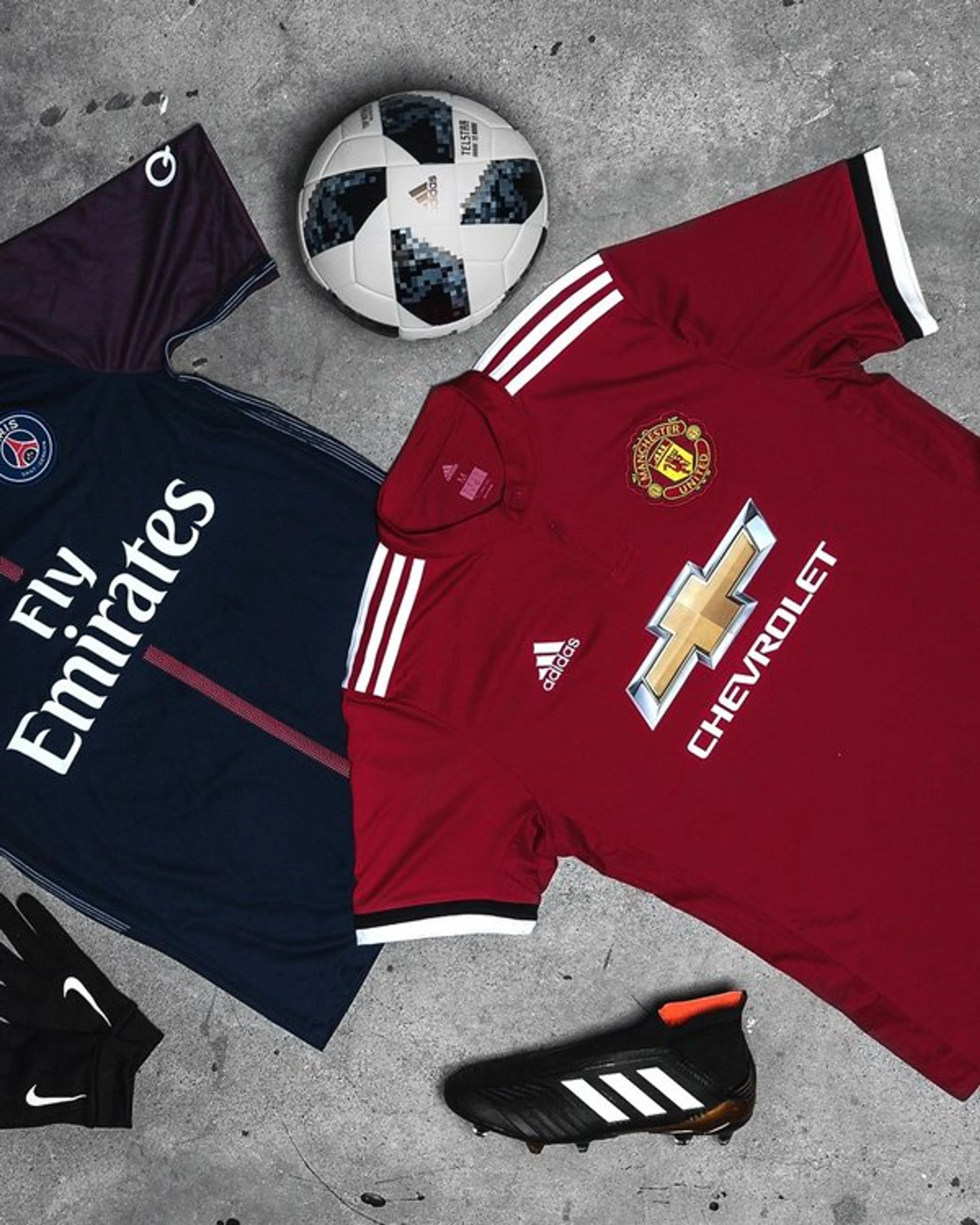 Football shirts, a ball and an Adidas boot arranged together